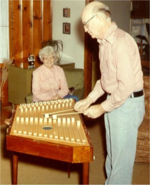Worley playing hammered dulcimer at home