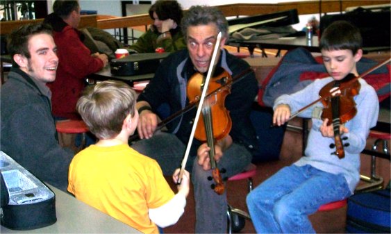 Keith teaching boys to fiddle