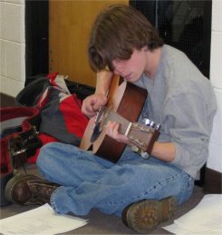 guitar player sitting on the floor jamming